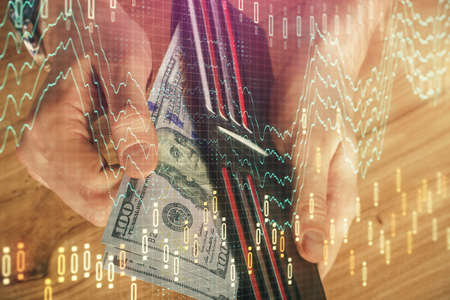 Multi exposure of forex graph drawing hologram and USA dollars bills and man hands. Technical...