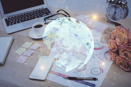 Computer on desktop with social network hologram. Double exposure. Concept of international people connections.の写真素材