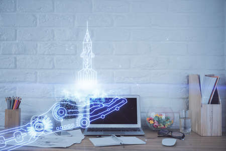 Desktop computer background in office and start up theme hologram drawing. Double exposure. Startup concept.の写真素材