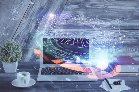 Double exposure of desktop computer and technology theme hologram. Concept of software development.