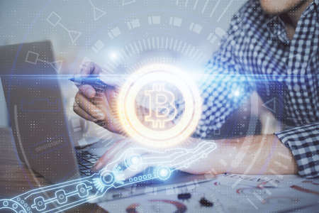 Blockchain theme hologram with man working on computer on background. Concept of crypto chain....