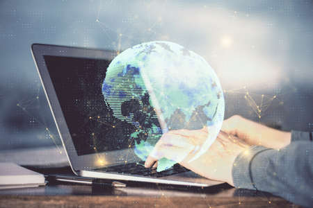 Social network theme hologram with businessman working on computer on background. Concept of world wide web. Multi exposure.の写真素材