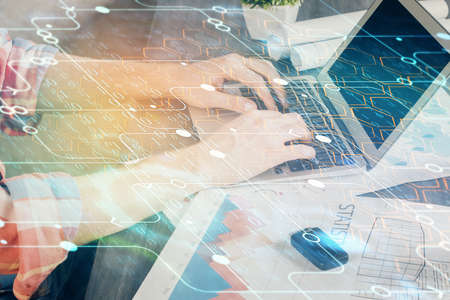 Multi exposure of technology hologram with man working on computer background. Concept of big data.の写真素材