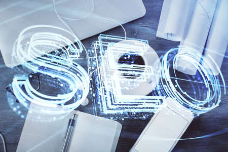 Double exposure of SEO drawing over study table background with computer. Concept of search. Top...