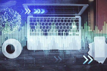 Stock market chart and top view computer on the table background. Double exposure. Concept of...