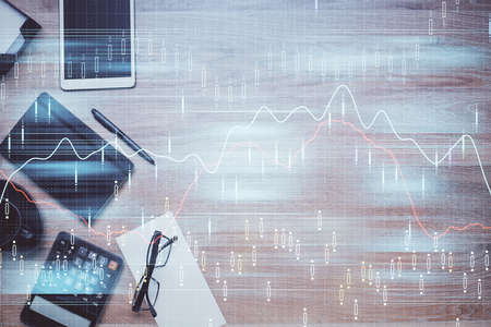 Double exposure of forex graph drawing and work table top veiw. Concept of financial analysis.