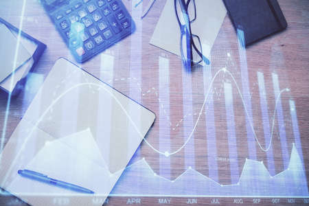 Double exposure of forex graph drawing and work table top veiw. Concept of financial analysis.