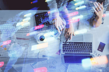 Double exposure of man and woman working together and data theme hologram drawing. Computer...