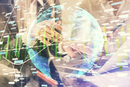 Double exposure of man and woman working together and financial theme hologram. international...