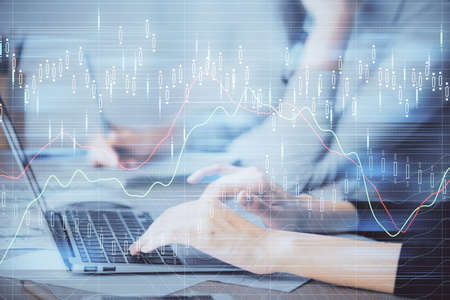 Multi exposure of woman hands typing on computer and financial chart hologram drawing. Stock market...