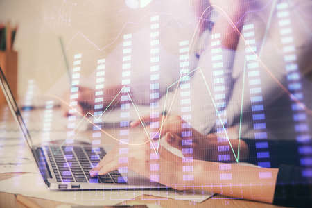 Multi exposure of woman hands typing on computer and financial chart hologram drawing. Stock market analysis concept.の写真素材