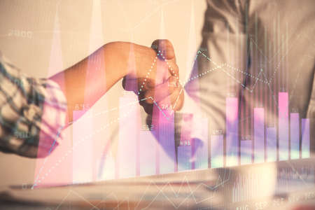 Double exposure of forex graph hologram and handshake of two men. Stock market concept.