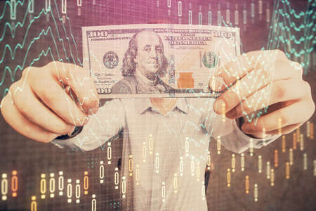 Multi exposure of forex graph drawing hologram and USA dollars bills and man hands. Technical...