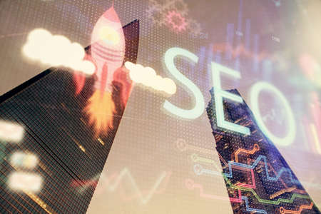 SEO hologram on city view with skyscrapers background double exposure. Search optimization concept.