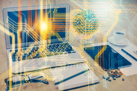 Double exposure of desktop with computer and world map hologram. International data network concept.