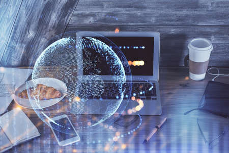 Multi exposure of table with computer and world map hologram. International data network concept.