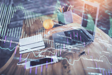 Financial market graph hologram and personal computer on background. Multi exposure. Concept of...