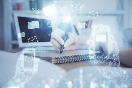 E-mail abstract envelop drawing over hands taking notes background. Concept of electronic mail....