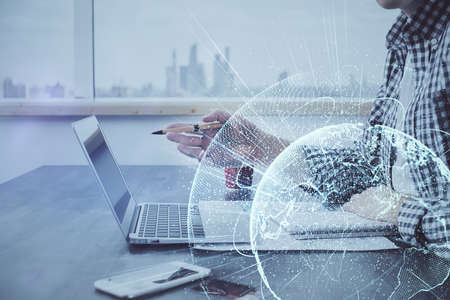 Social network theme hologram with businessman working on computer on background. Concept of world...