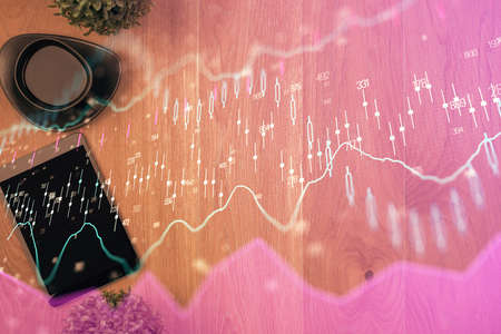 Multi exposure of financial chart hologram over desktop with phone. Top view. Mobile trade platform...