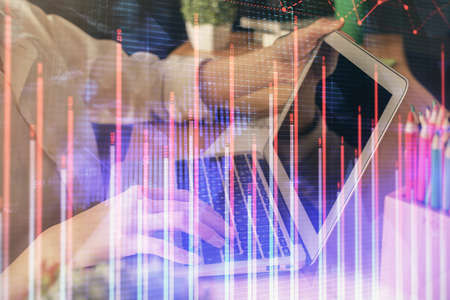 Double exposure of woman hands typing on computer and forex chart hologram drawing. Stock market...