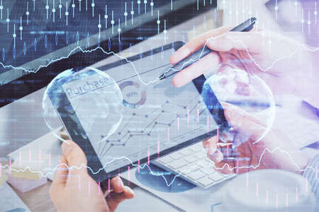 Double exposure of mans hands holding and using a phone and financial chart drawing. Market analysis...