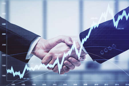 Double exposure of forex graph hologram and handshake of two men. Stock market concept.