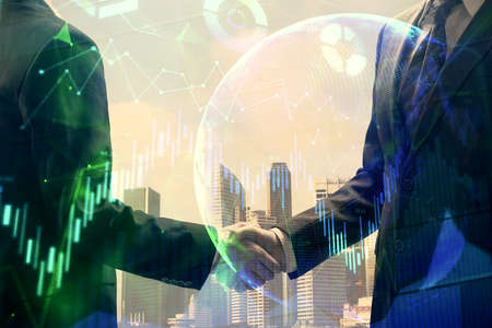 Double exposure of forex graph hologram and handshake of two men. Stock market concept.