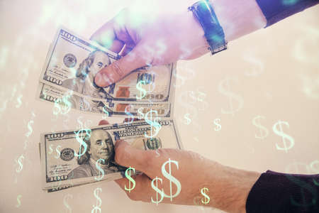 Multi exposure of financial graph drawing hologram and USA dollars bills and man hands. Analysis...