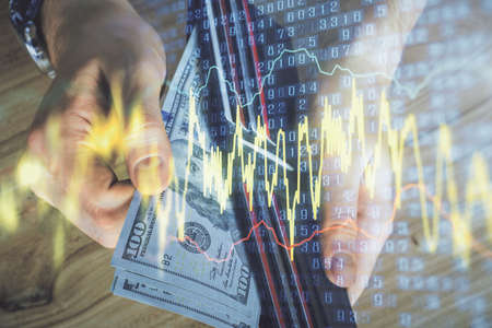 Multi exposure of forex graph drawing hologram and USA dollars bills and man hands. Technical...