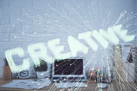 Desktop computer background in office and start up theme hologram drawing. Double exposure. Startup concept.の写真素材