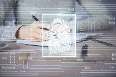 Blue fingerprint hologram over womans hands taking notes background. Concept of protection. Double exposureの写真素材
