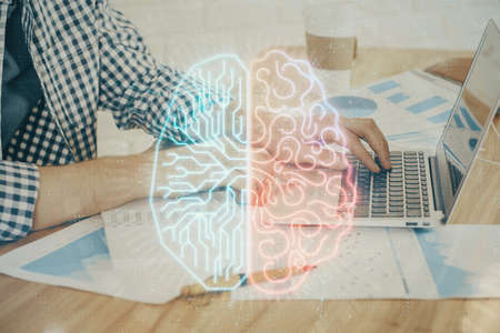 Man typing on keyboard background with brain hologram. Concept of big Data. Double exposure.の写真素材