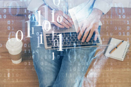 Multi exposure of data internet theme hologram with man working on computer on background. Concept...