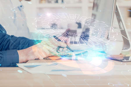 Double exposure of data internet theme hologram with man working on computer on background. Concept...