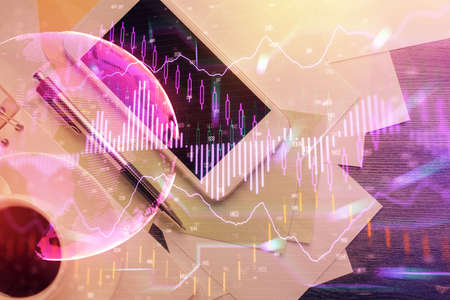 Multi exposure of forex graph hologram over desktop with phone. Top view. Mobile trade platform...