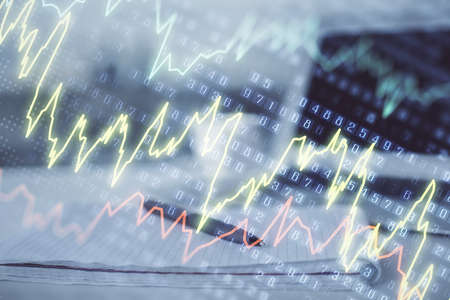 Double exposure of financial graph drawings and desk with open notebook background. Concept of forex...