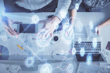 Double exposure of man and woman working together and data theme hologram drawing. Computer...