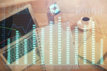 Double exposure of businesswoman hands typing on computer and forex chart hologram drawing....