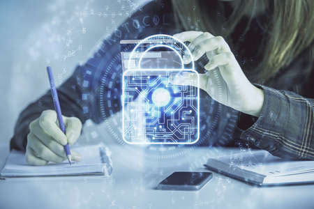 Double exposure of woman on-line shopping holding a credit card and Lock hologram drawing. Security...