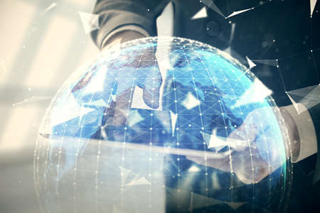 Double exposure of mans hands holding and using a phone and international business theme drawing.