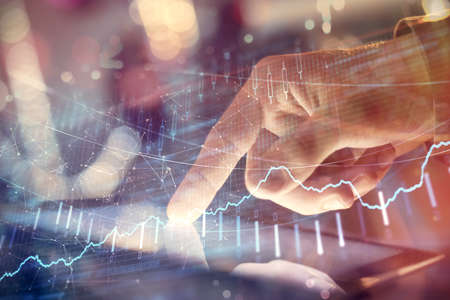 Multi exposure of mans hands holding and using a phone and financial chart drawing. Market analysis...