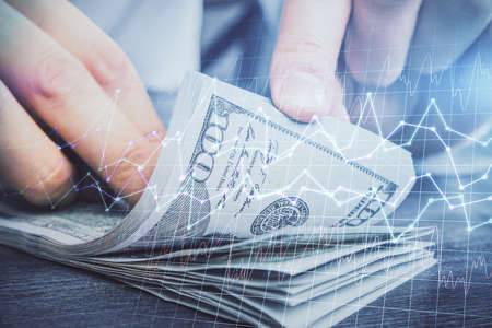 Multi exposure of forex graph drawing hologram and USA dollars bills and man hands. Technical...
