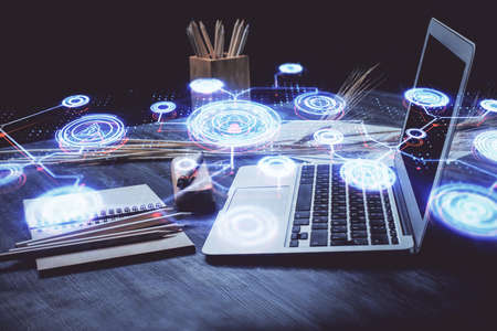 Computer on desktop with social network hologram. Double exposure. Concept of international people connections.の写真素材