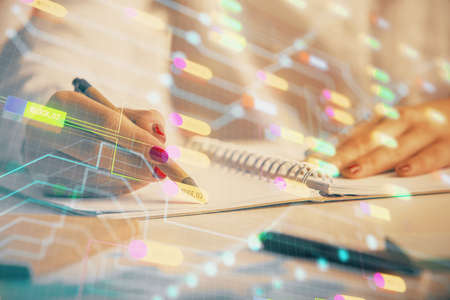 Multi exposure of womans writing hand on background with data technology hologram. Concept of...