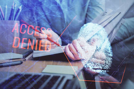 Blue fingerprint hologram over womans hands taking notes background. Concept of protection. Double...