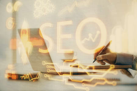 Double exposure of seo icon with man working on computer on background. Concept of search engine...