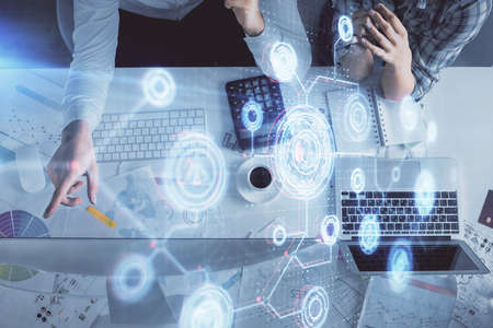 Double exposure of man and woman working together and data theme hologram drawing. Computer...