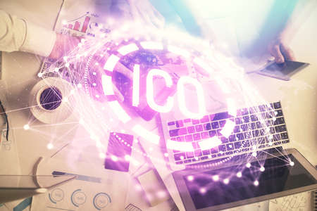 Double exposure of man and woman working together and crypto theme hologram drawing. Computer background. Blockchain concept. Top View.の写真素材