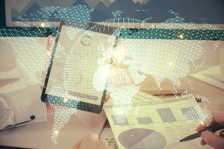 Double exposure of mans hands holding and using a phone and international business theme drawing.
